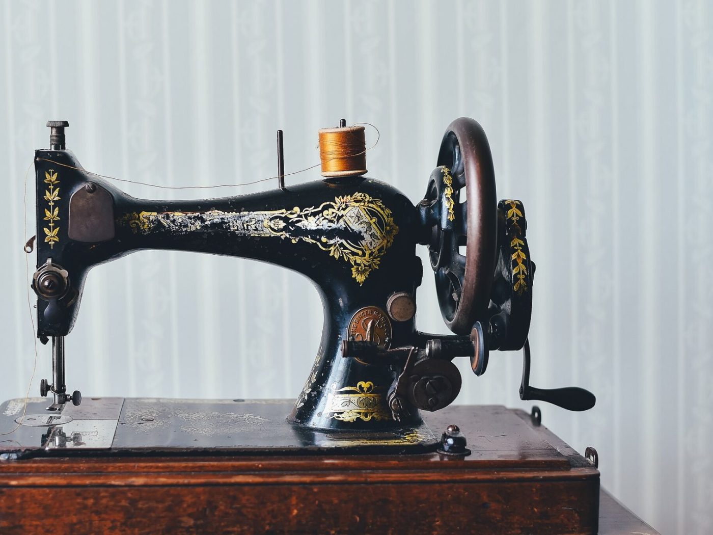 Antique sewing machine with gilt filigree decoration on a black lacquer body