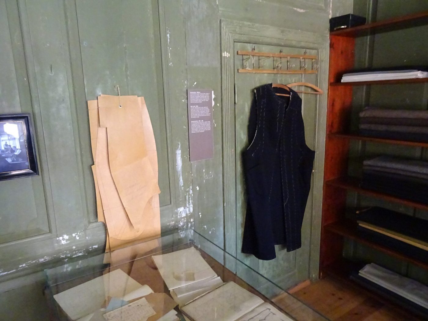Tailoring atelier interior with pattern pieces and garments on a rail